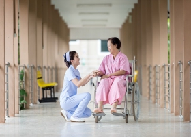 A nurse speaking to a patient. A nurse speaking to a patient.