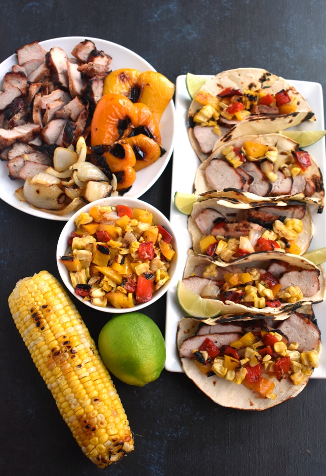 Grilled Corn Salsa Pork Tacos feature a grilled corn, red pepper and onion salsa with flavorful garlic herb pork loin and toasted corn tortillas which are ready in just 25 minutes! www,nutritionistreviews.com
