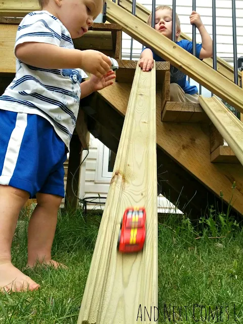 Kids racing cars on DIY wood ramps