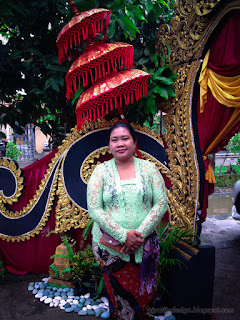 Girl With Balinese Clothes Attending A Wedding Invitation At The Front Of Wedding Gate Style, Bali, Indonesia