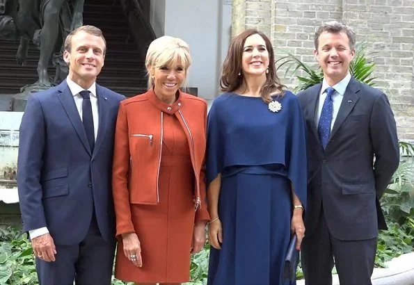 Brigitte Macron wore a dress by Louis Vuitton. Crown Princess Mary wore Stella McCartney cape gown. President Emmanuel Macron