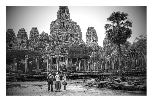 A full view of Bayon Temple with its stone faces on the towers at Angkor Province in Siem Reap, Cambodia A full view of Bayon Temple with its stone faces on the towers at Angkor Province in Siem Reap, Cambodia