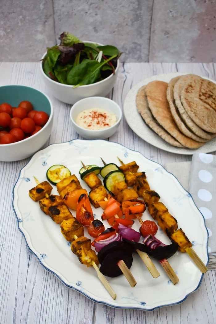 Grilled Tandoori Tofu Skewers served with wholemeal pitta bread, salad leaves, cherry tomatoes and hummus