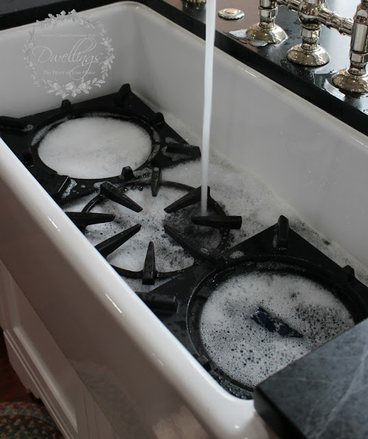 I fill the sink with towels and place the gas range top grates on top, then fill with hot soapy water.
