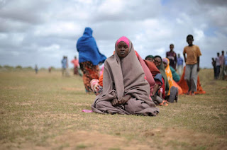 Women waiting for food aid at a distribution center in the city of Afgoye, Somalia.