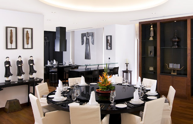 Picture of the round black dining table and modern white chairs 