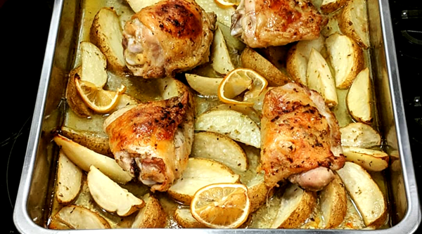 image of chicken and potatoes in the pan, fresh out of the oven