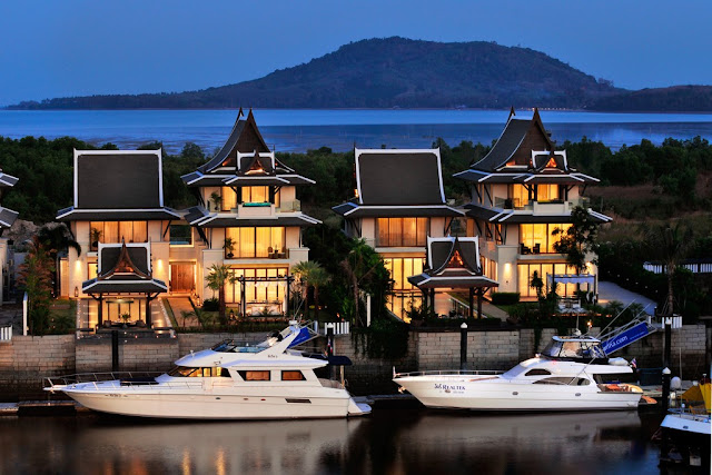Picture of two modern villas with private yacht docks and yachts 