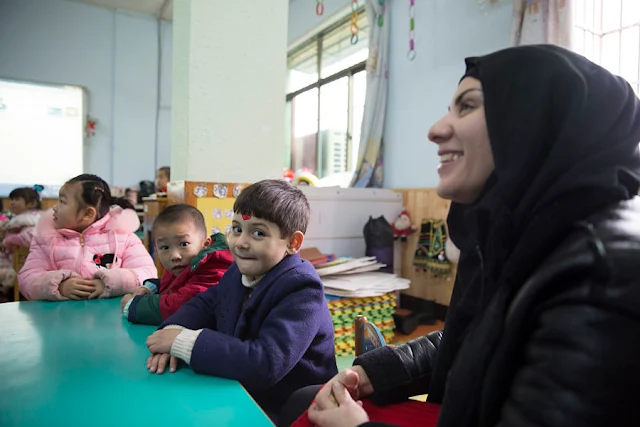 Manar Abdulhussein (L), 38, an Iraqi migrant, laughs in a kindergarten her son attends in Yiwu, China 11 January 2017. In 2016, Yiwu, Zhejiang Province, issued 9,675 people with temporary residence permits, nearly half of them from war-torn countries including Iraq, Yemen, Syria and Afghanistan. To match story CHINA-MIGRANTS/MIDEAST Thomson Reuters Foundation