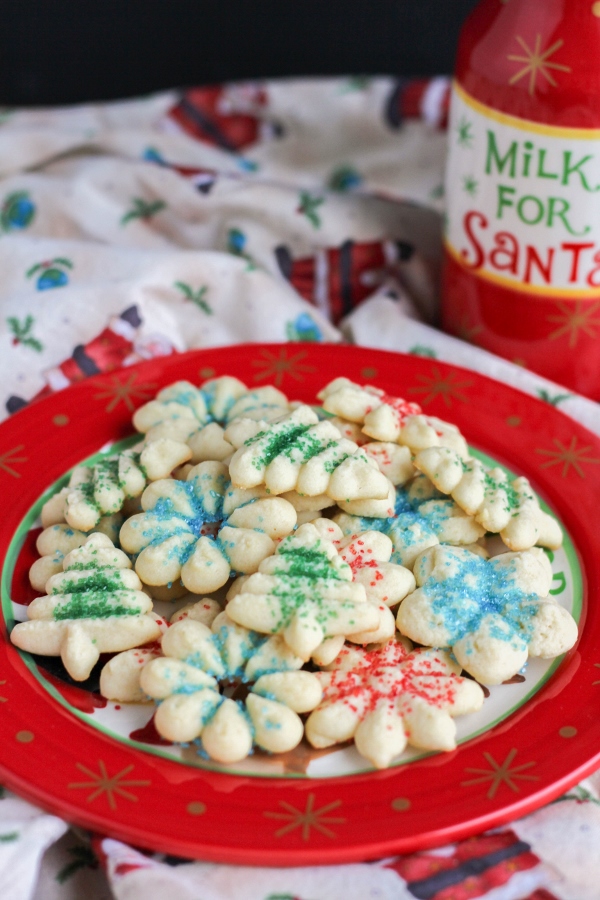 These Spritz Cookies are crisp and buttery and have a rich vanilla flavor. Just a few simple ingredients and a cookie press are all you need to make these Christmas classics!