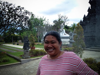 Woman Traveler laughing splashed with water from plants In The Garden North Bali Indonesia