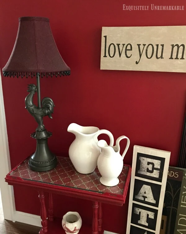 Fabric Topped Table in a red painted hallway