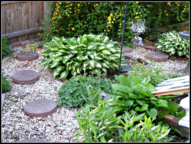 Perennial garden with pea gravel and stepping stones