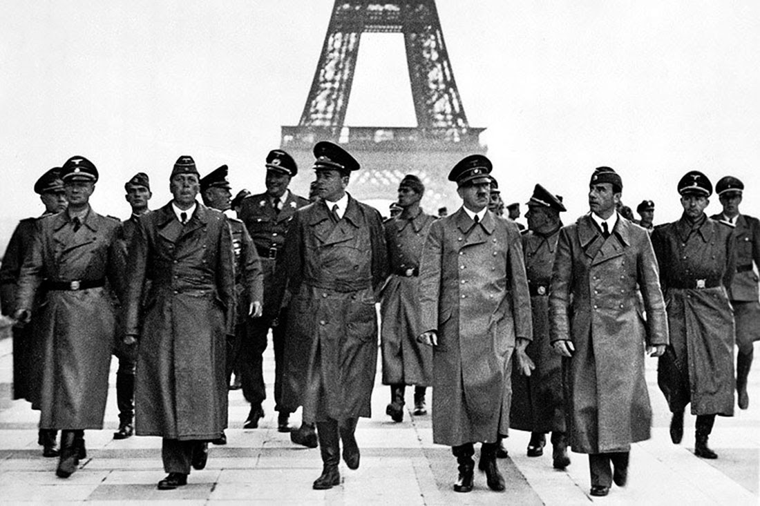 Adolf Hitler with other German officials walking in front of the Eiffel Tower in Paris, 1940.