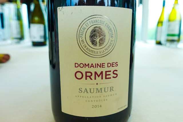 A close up of Saumur wine bottle which has a finger print tree on the label