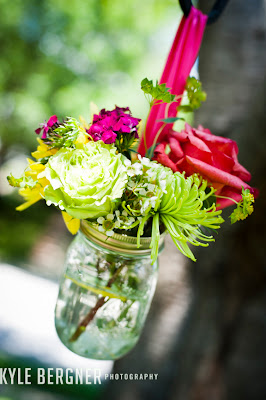Colorful mason jar floral arrangement by DellaBlooms