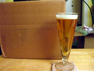Rye saison next to a box of hops.