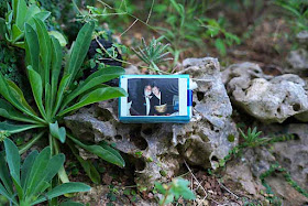 cigarette pack, Polaroid photo, rock garden