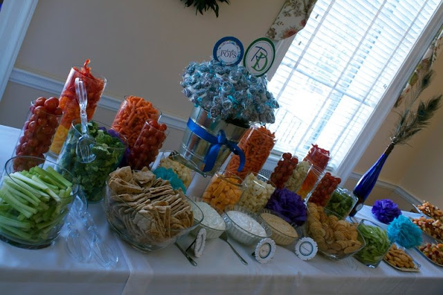 A group of people sitting at a table with a cake