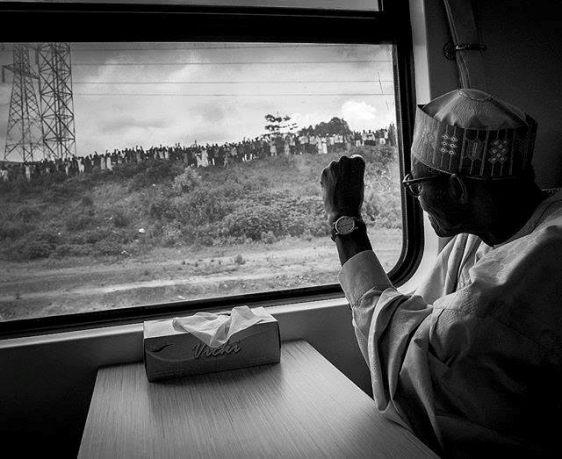 Photo: President Buhari hails back at residents as he rides the newly-commissioned train