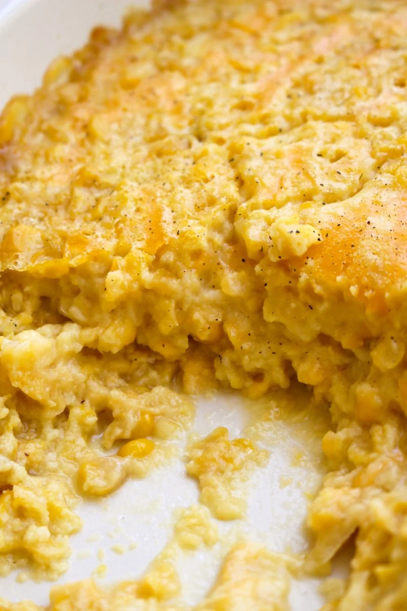 This Baked Creamed Corn is super easy to make and goes with any protein. It's easy enough to make on a weeknight and makes a great holiday side dish, too! #sidedish #cornrecipe