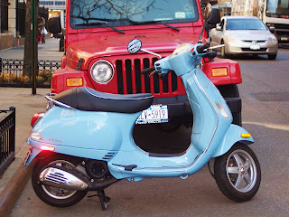 New York City, powder blue scooter, red jeep