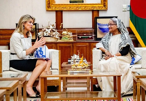 Queen Maxima wore a floral print silk blouse and floral print silk midi skirt, and Ntan pumps, fruit earrings, One & Only clutch