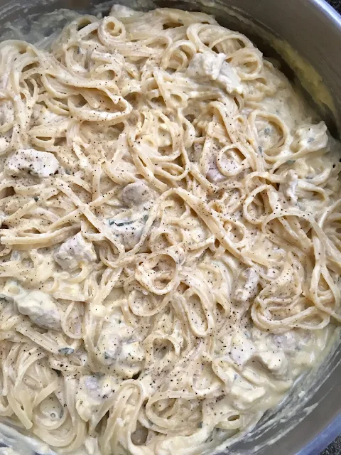 Pasta tossed together with pumpkin Alfredo sauce and chicken.