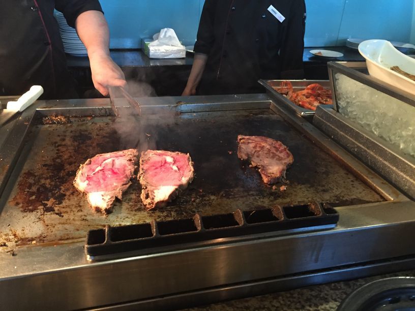 Steaks on the grill at Seven Corners Restaurant