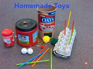 Text: Homemade Toys  Picture: toys made from recycled materials. Peanut butter jar rattle, coffee can coin drop, oat container ball drop with 2 plastic golf balls and yellow and green puff ball, egg carton straw game and colorful straws