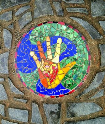 Mosaic of a hand. Dear Quakers, do you recognize the visual allusion?