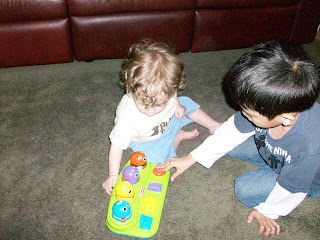 Baby Tyler and big brother David playing with birthday toy