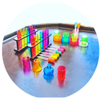 potion making tuff tray with potion bottles, pipettes, rainbow test tubes