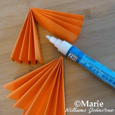 Orange color paper and an adhesive zig glue pen