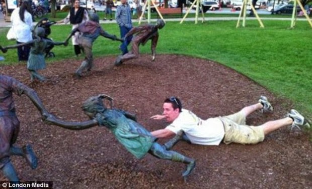 Tourist Posing Inappropriately with Statues 8