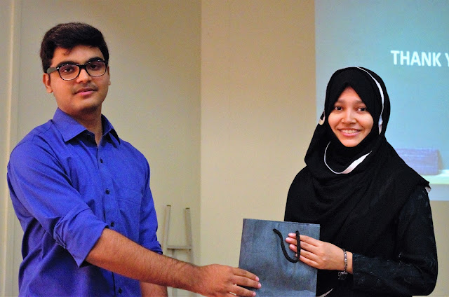 Syed Faizan Ali giving gifts to the winner of the Q/A Session