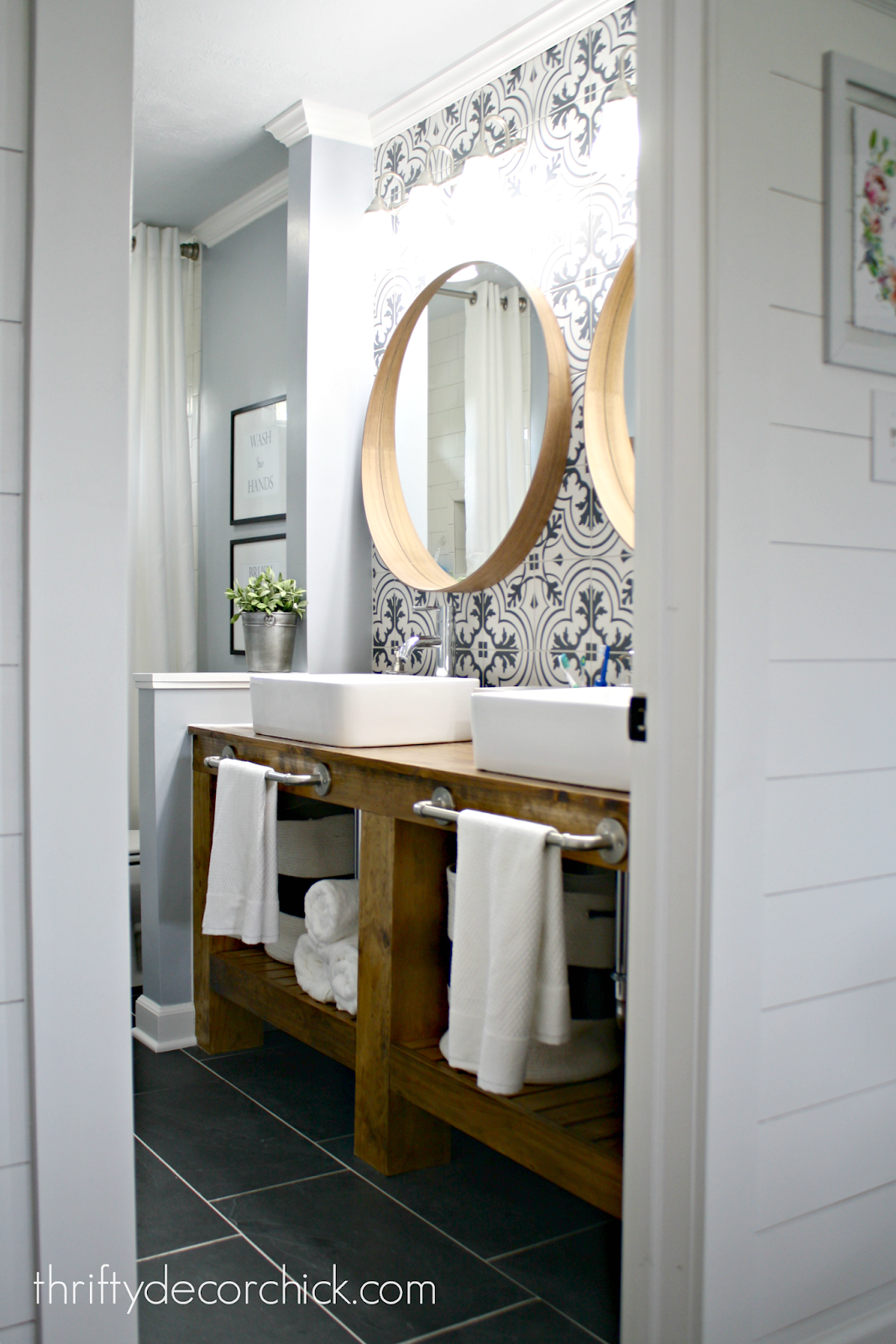 Bathroom makeover with dark gray tile, cement tile backsplash and wood vanity 