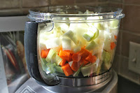 Onions, carrots, fennel, and leeks in food processor