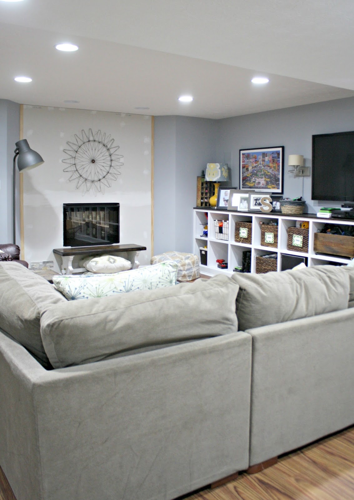 basement family room with DIY fireplace