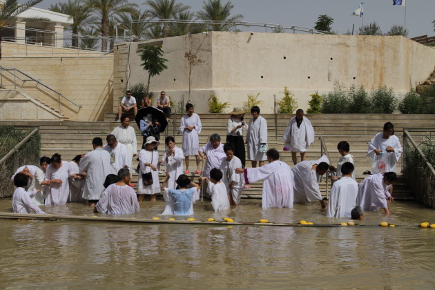Pilgrims getting baptized at Bethany on the Israel side of the Jordan river
