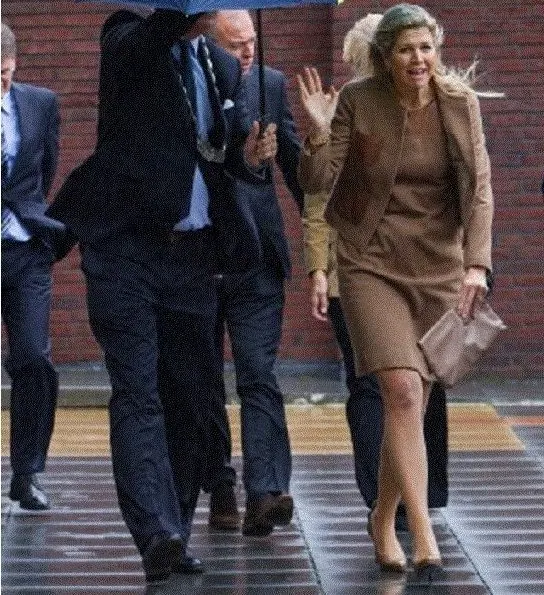 Dutch Princess Maxima attends the national school breakfast at the Zonnewijzer school in Leidschendam on a very windy day. she wore Natan dress