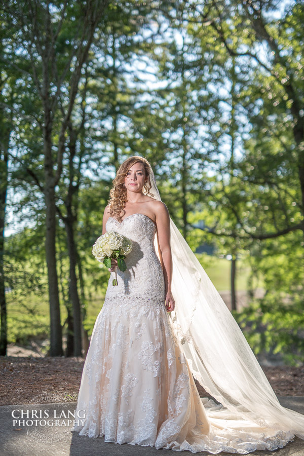 Image of Bride in a wedding dress at River Landing in front of the clubhouse