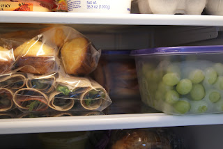 Prepped lunches in plastic bags and plastic containers, in the refrigerator.