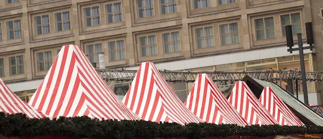 Red-striped tents at the Alexanderplatz Christmas Market in Berlin, Germany
