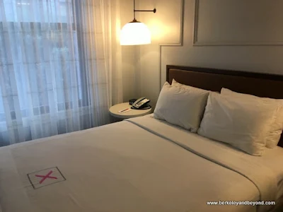 guest room bed at Axiom Hotel in San Francisco, California