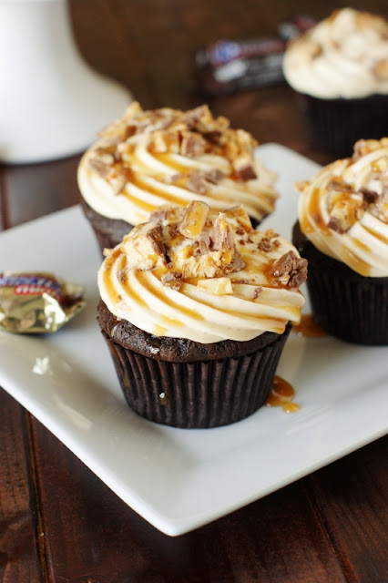 Snickers Cupcakes ~ rich chocolate cupcakes loaded with caramel frosting & a Snickers mini tucked inside!   www.thekitchenismyplayground.com