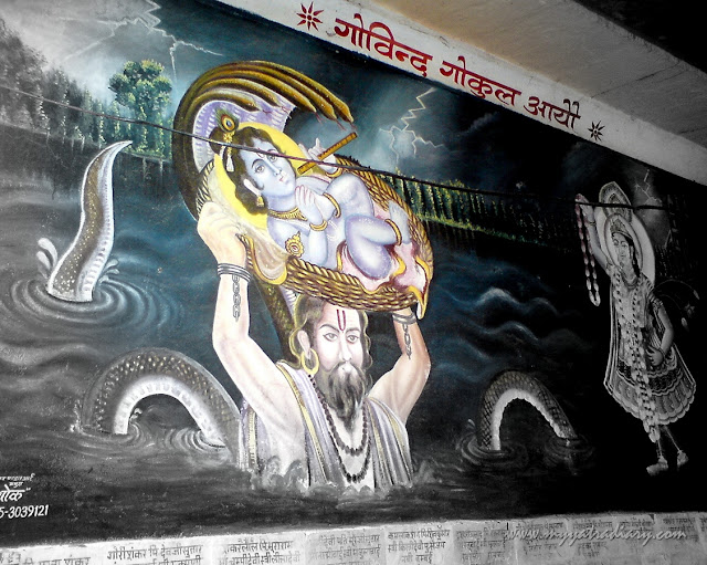 A painting depicts Krishna crossing the Yamuna at Chaurasi Khamba Temple,  Old Gokul Mahavan
