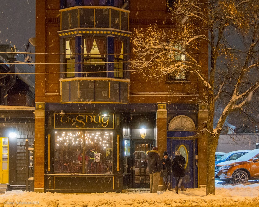 Portland, Maine USA January 2018 photo by Corey Templeton. Passing by The Snug, a pub, a 223 Congress Street this evening. It's so nice walking around in the snow when it is around 20 degrees fahrenheit, compared to the colder recent temperatures. 