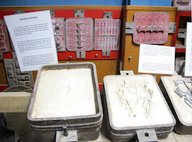 Display showing how metal toys are sandcast.