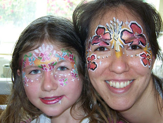 Mom and daughter with faces painted with flowers